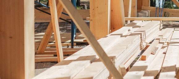 Stacked lumber outdoors, prepped for use.